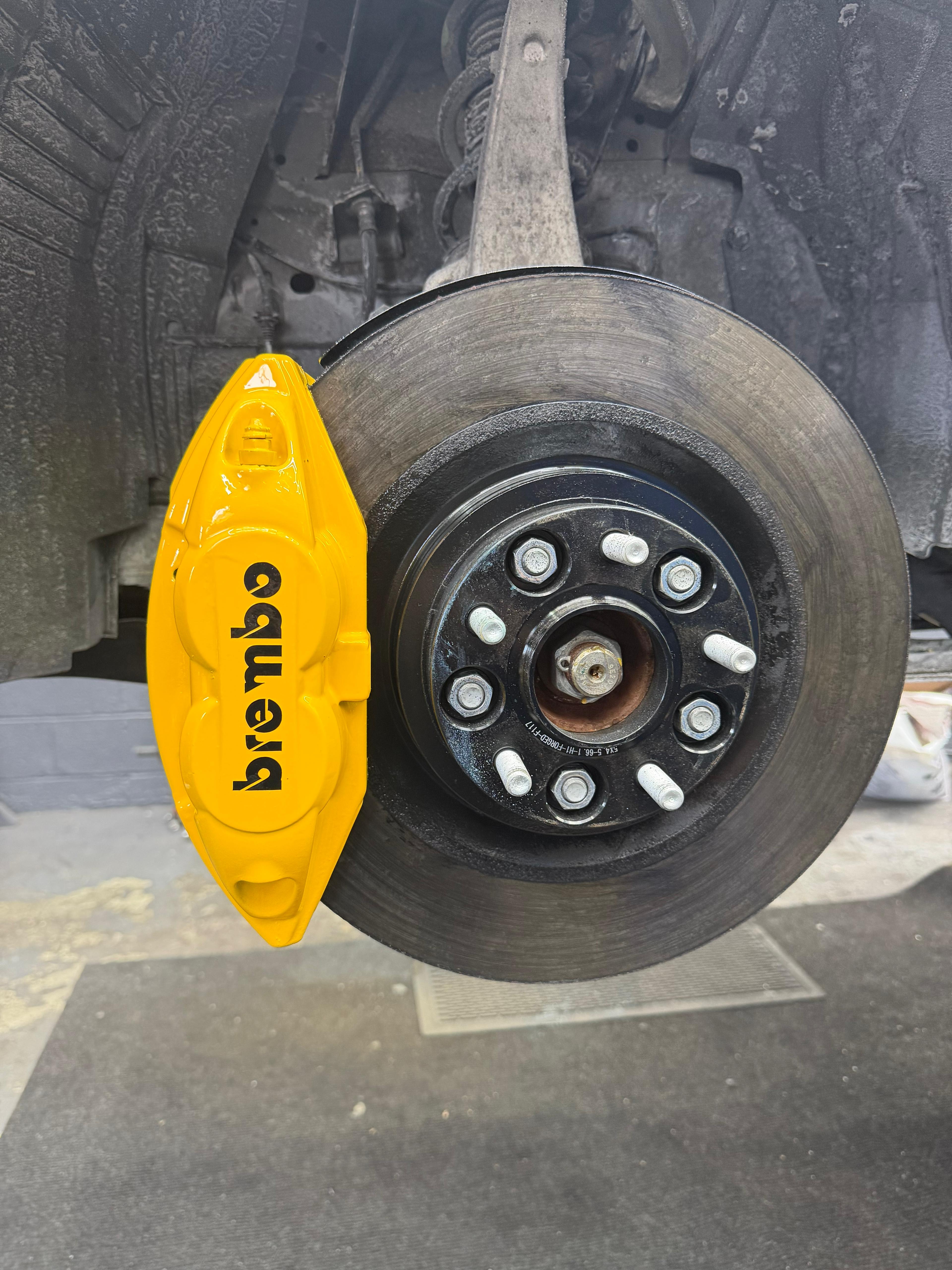 Yellow Brembo caliper with gloss finish