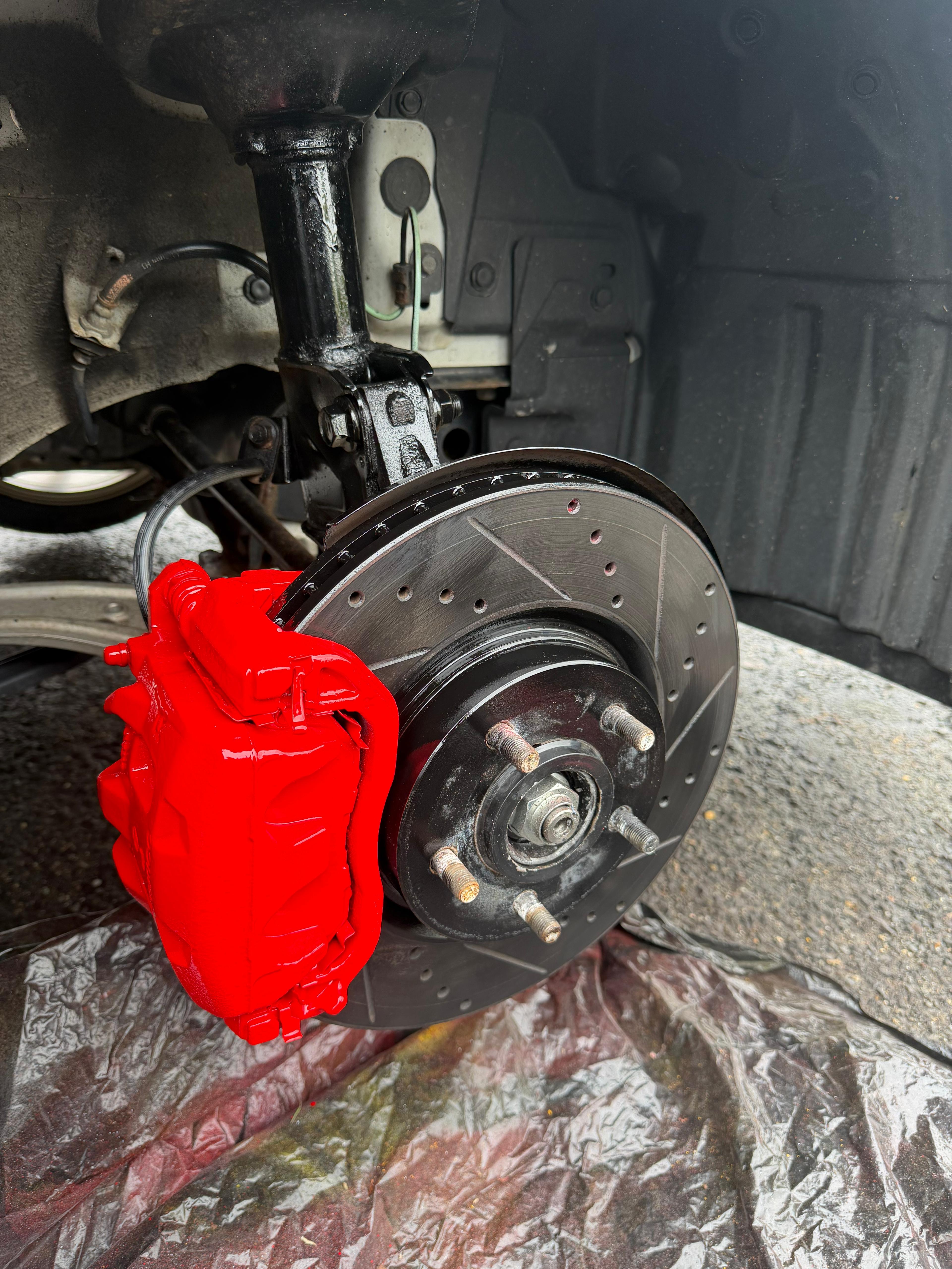 Red caliper — drilled & slotted rotor upgrade