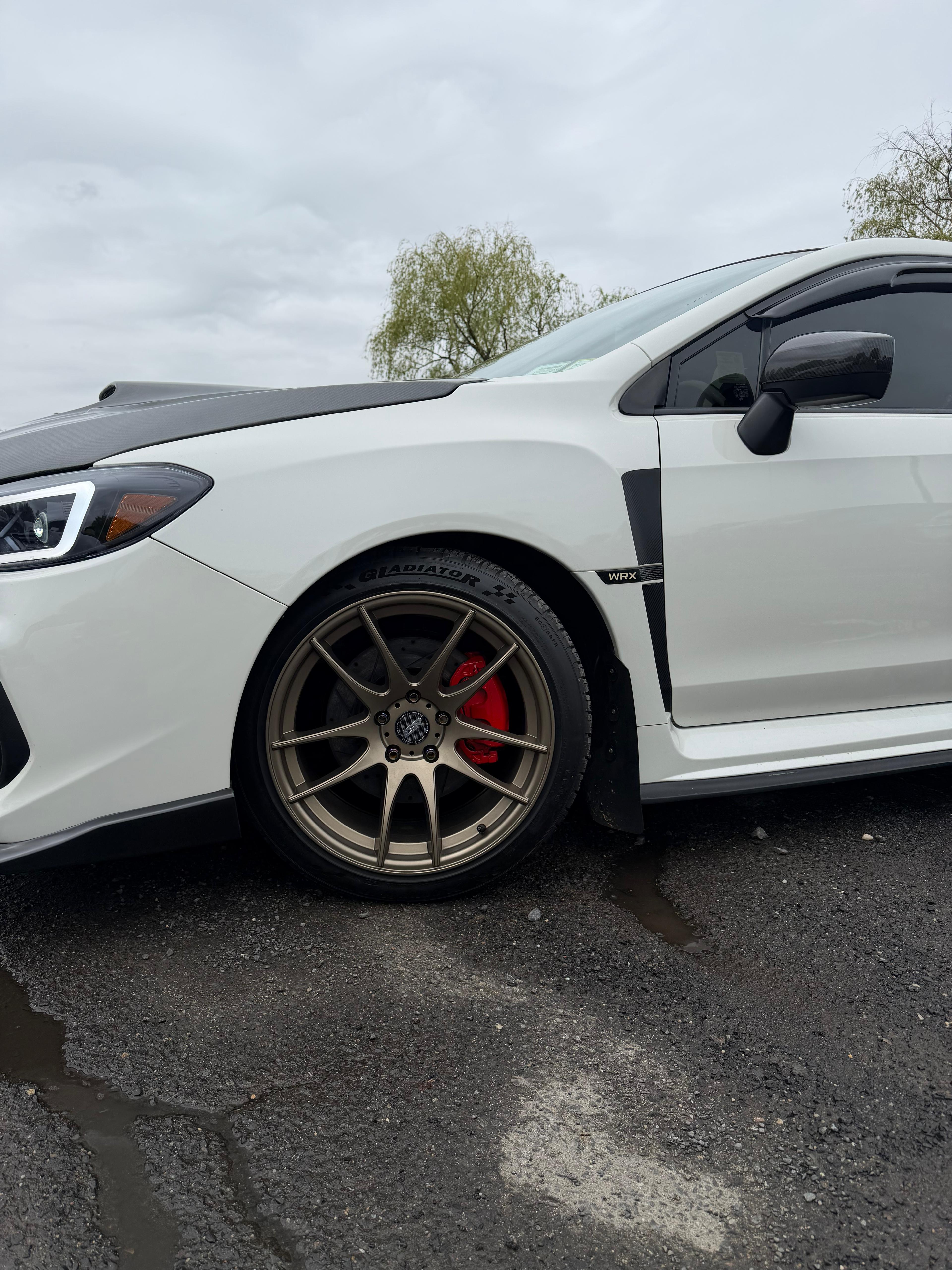 Red calipers — Subaru WRX with bronze wheels